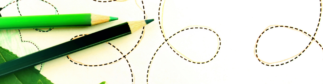 two pencils on a piece of paper. The paper has squiggly patterns of dotted lines