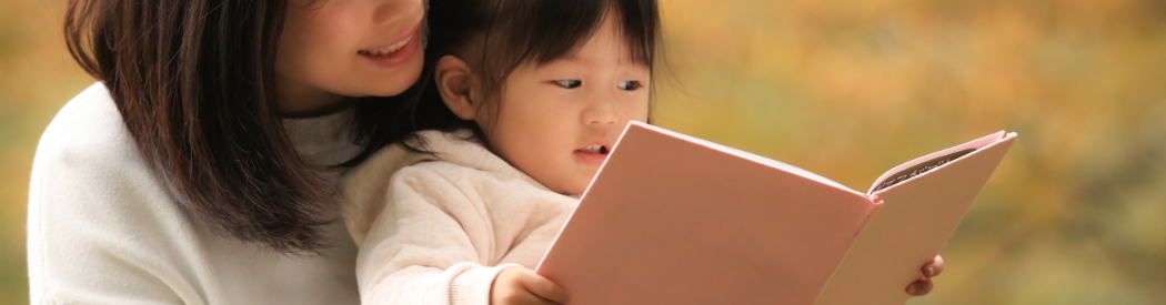 child and parent reading together