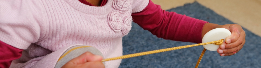 child engaging with weaving activity
