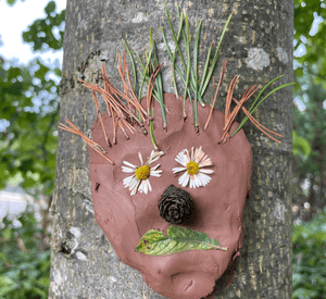 creating forest faces on tree trunks with clay and natural finds