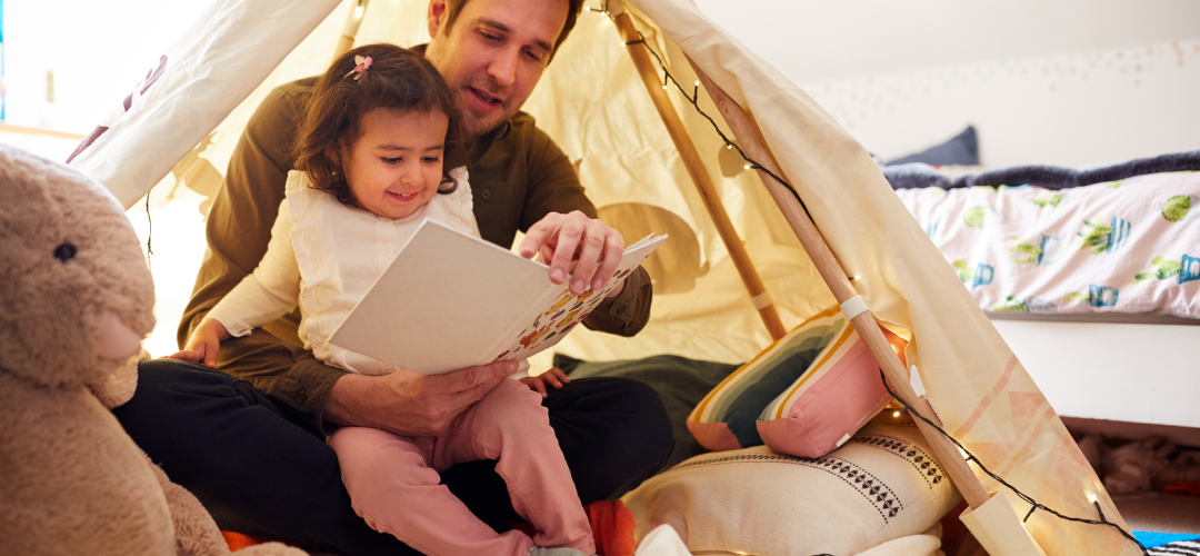 Child reading in a den 