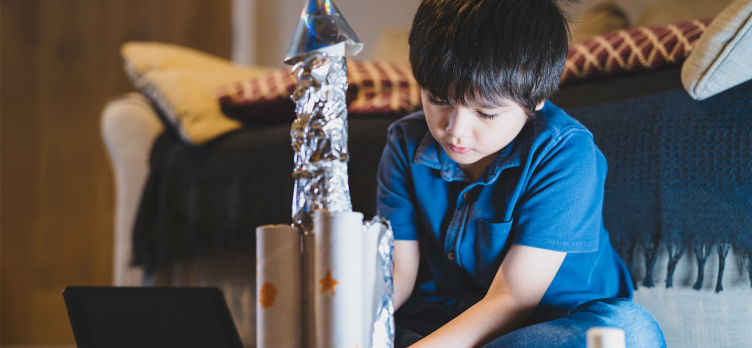 child making toilet roll rocket