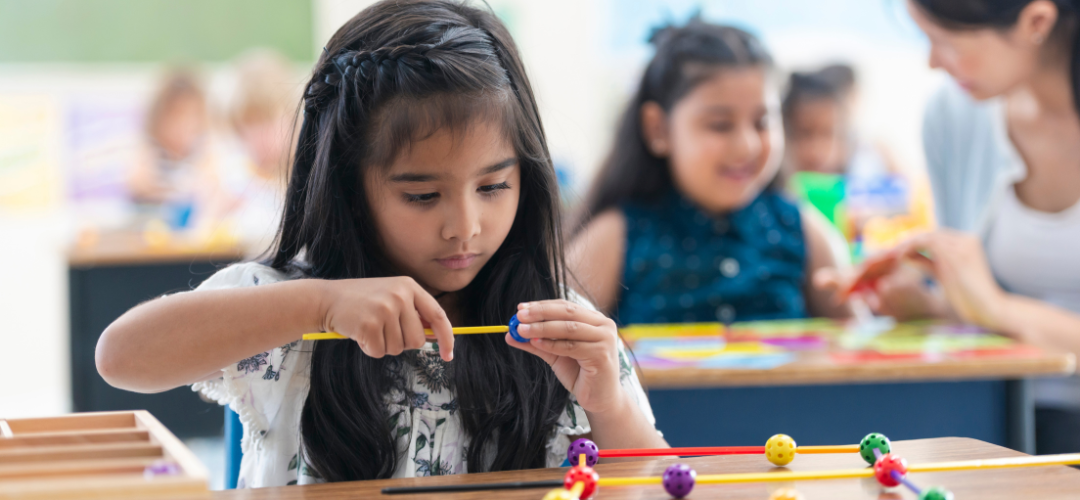 Children in a classroom setting taking part in a STEAM activity
