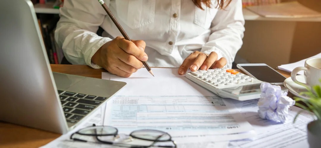 woman holding pencil and reading documents