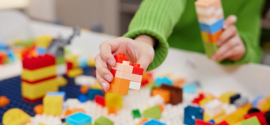 child showing multi-coloured blocks