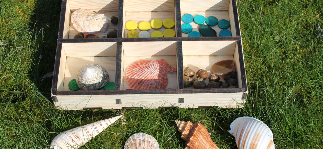 loose parts resources sorted in wooden box