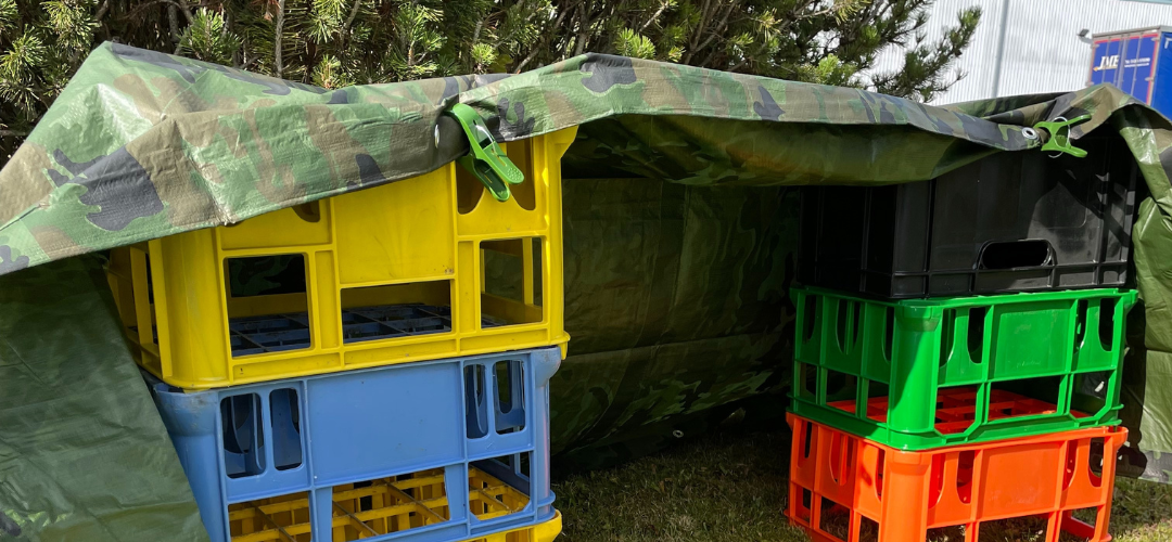indoor den made with milk crates and camouflage fabric