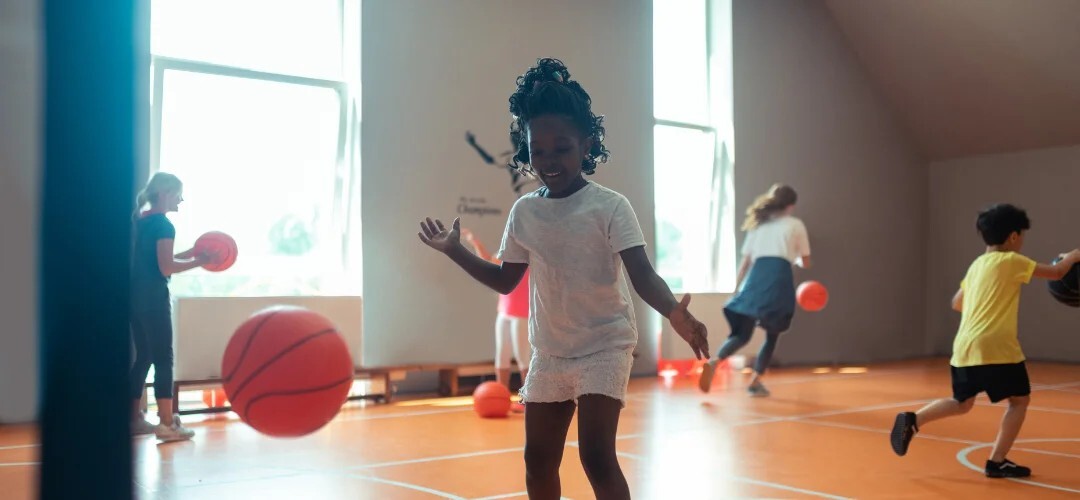 child playing with basketball