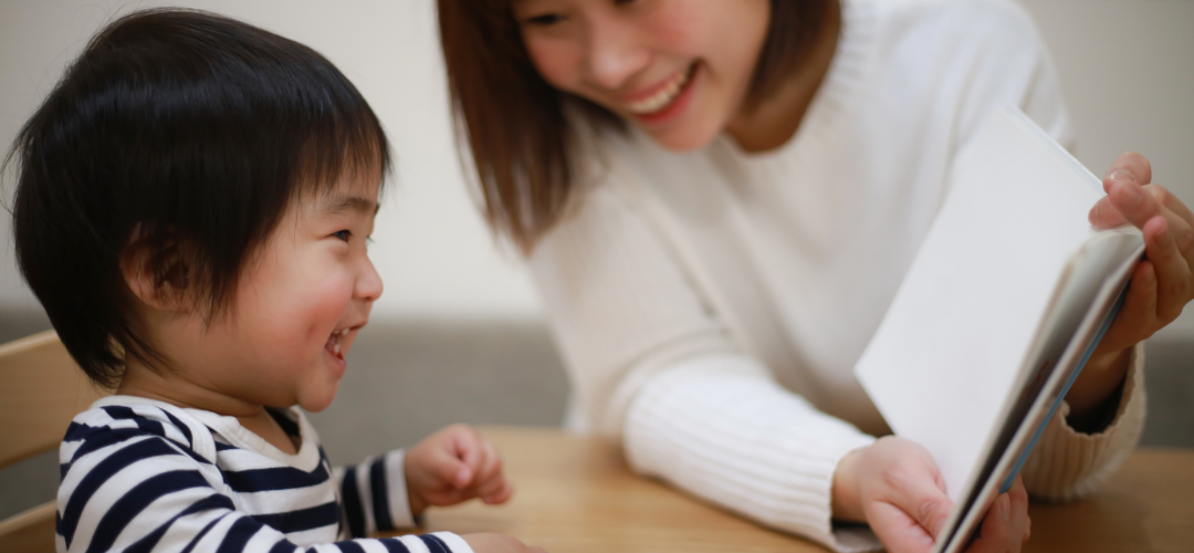 child reading with his parent
