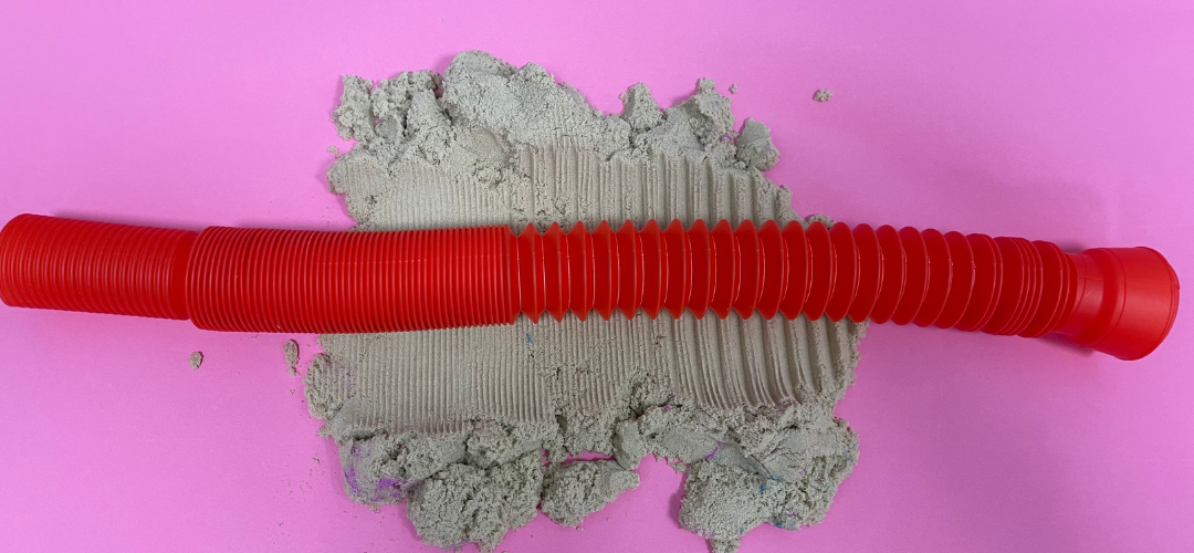 sensory fidget tube rolled in sand