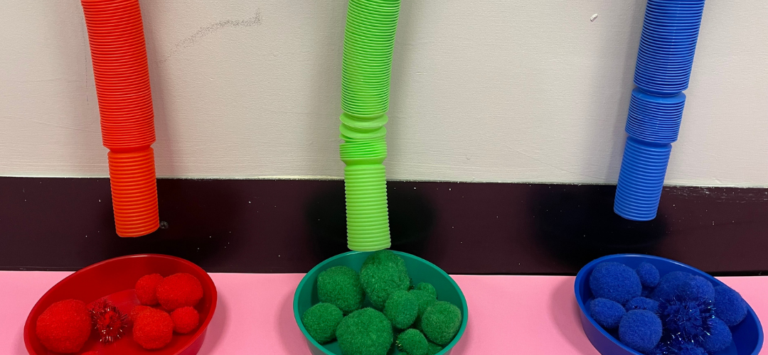 fidget tube sorting activity with pom poms 