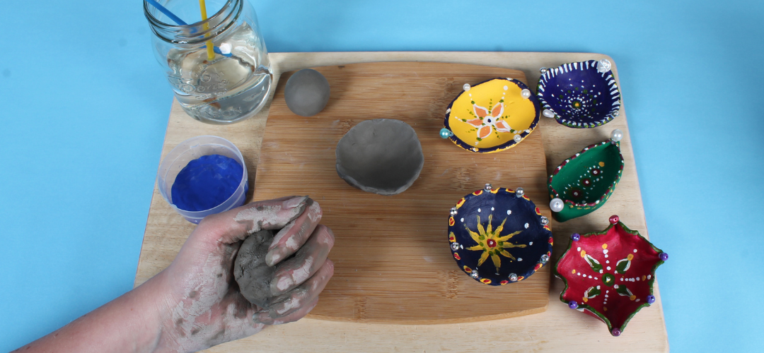 child holding grey clay