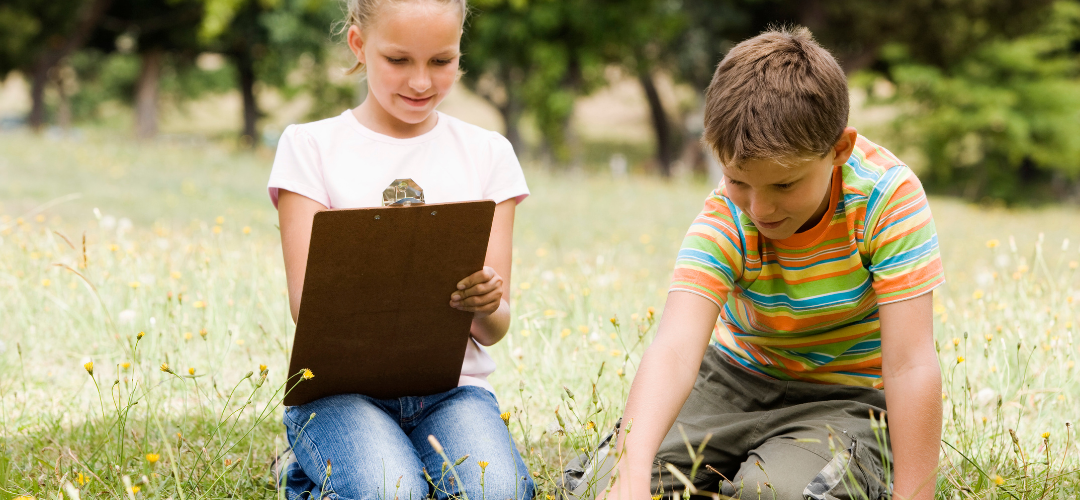 children using a clipboard outdoors