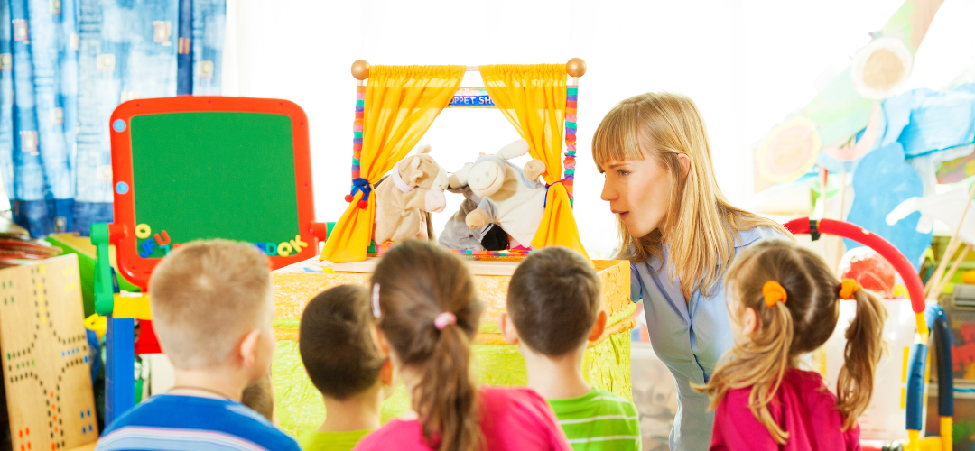 teacher putting on a puppet show for children