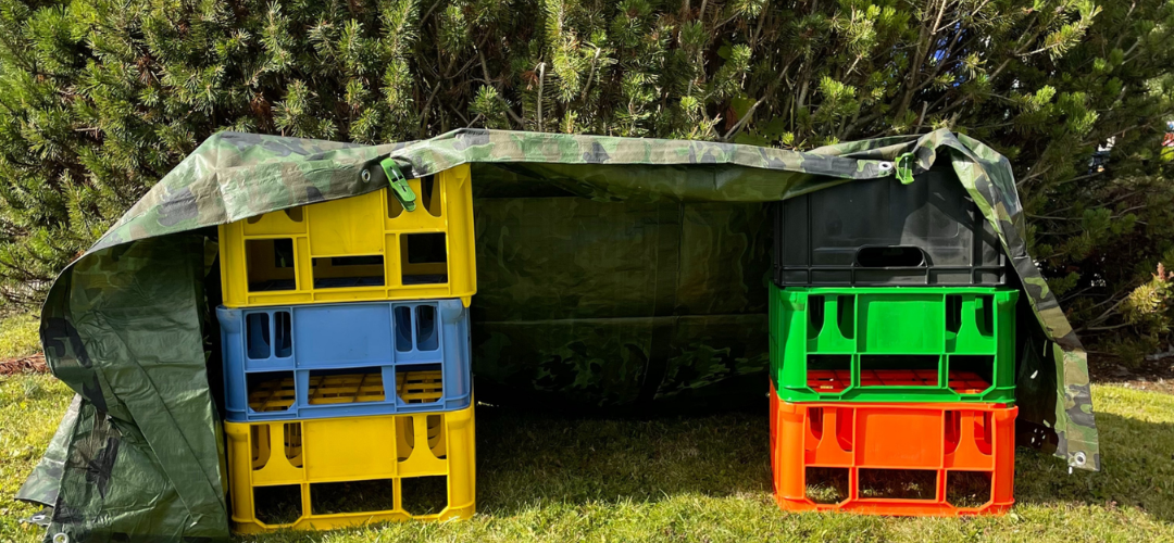 den made from tarp, pegs and crates