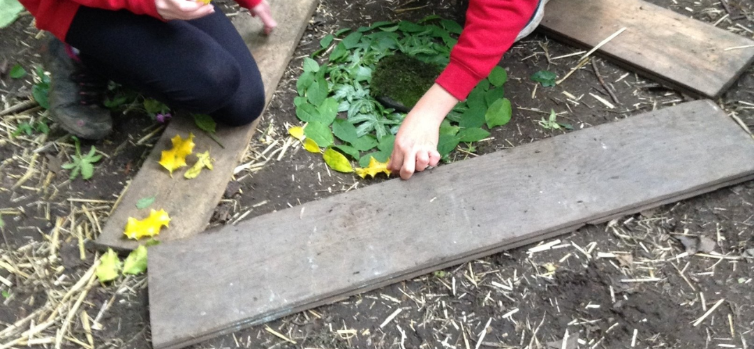 children creating transient art using natural resources