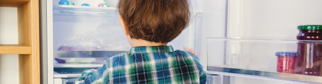 child looking into the fridge