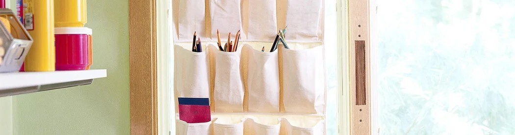 shoe holder on the back of the door with art supplies in 