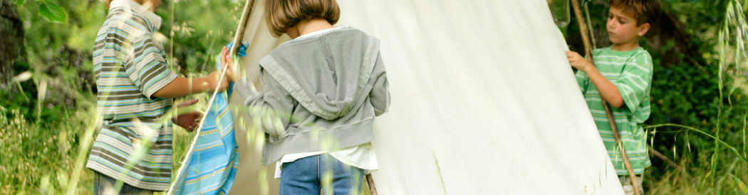 children putting up tent in the outdoors