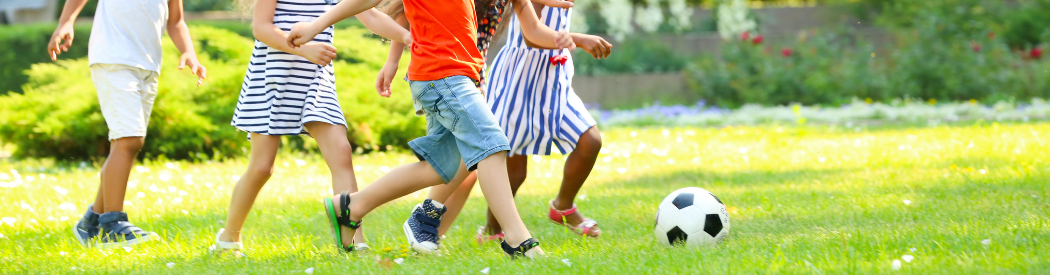 children playing outside with football