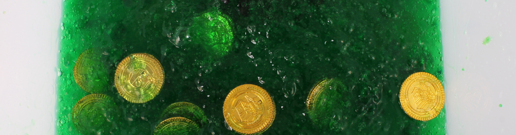plastic coins buried in green slime