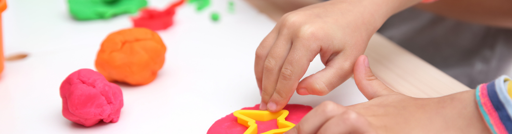 child playing with play dough