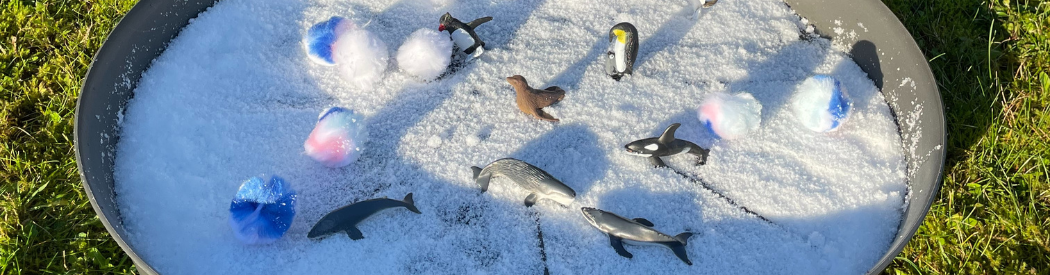 fake snow in a tuff tray with small world toys