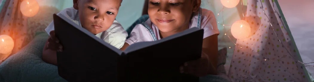children reading in a den