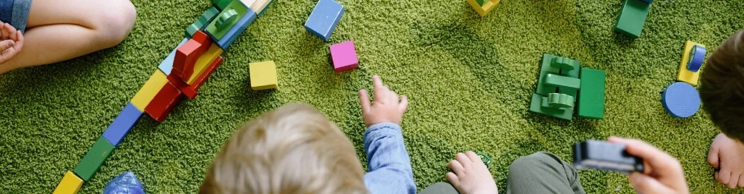 children playing together with an assortment of toys