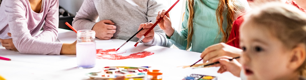 children painting in a group
