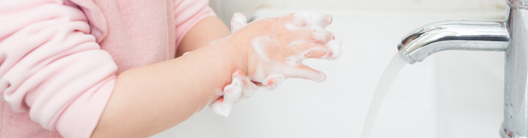 child washing their hands