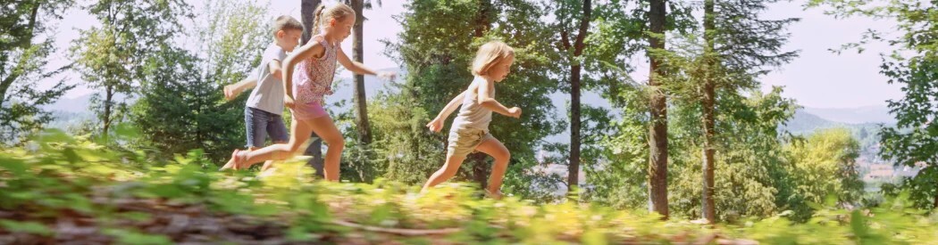 three children running outdoors