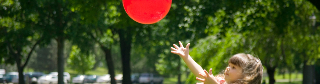 child catching red balloon