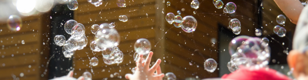 children touching bubbles
