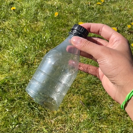 person holding top end of bottle
