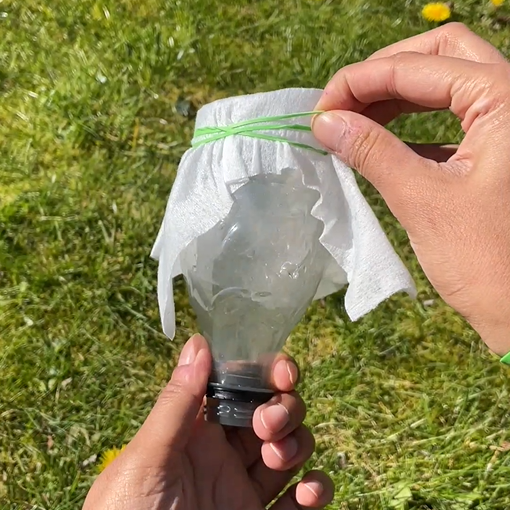 attaching wipe to bottle using rubber band