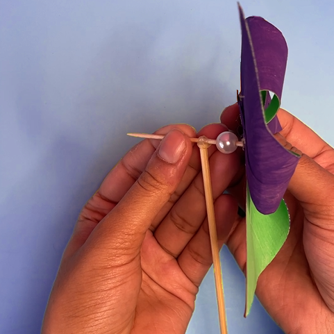 person making paper windmill