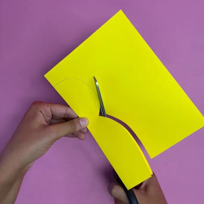 Person cutting yellow card