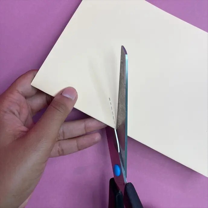 Person cutting cream card