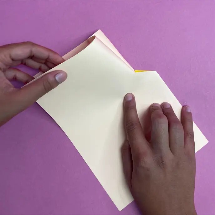 Person folding cream card