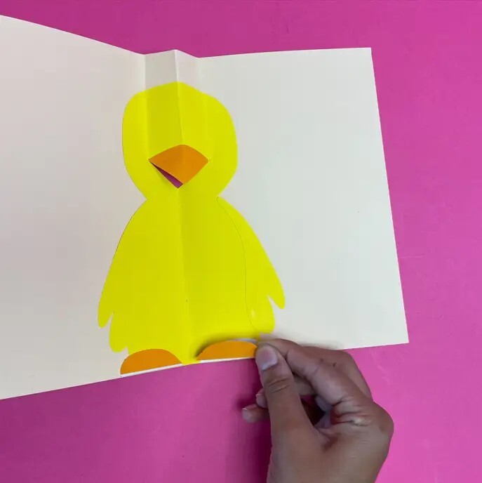 Person gluing legs on easter chick card