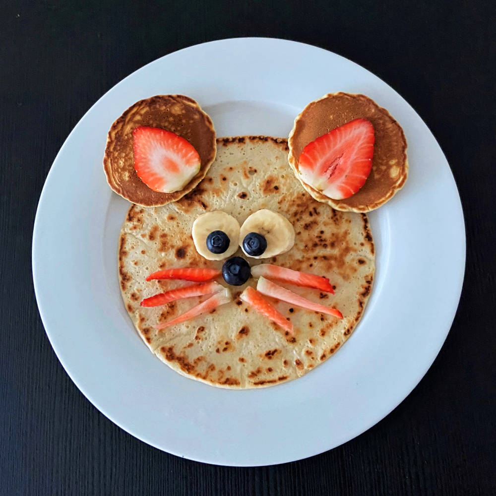 mouse pancake made using strawberries and blueberries