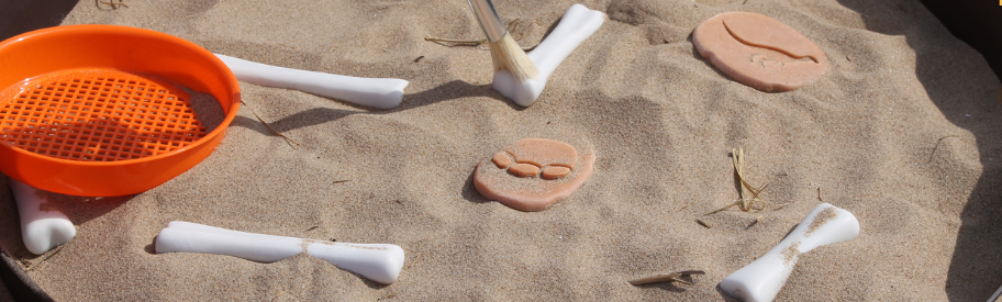 Dinosaur excavation sand tuff tray sensory play