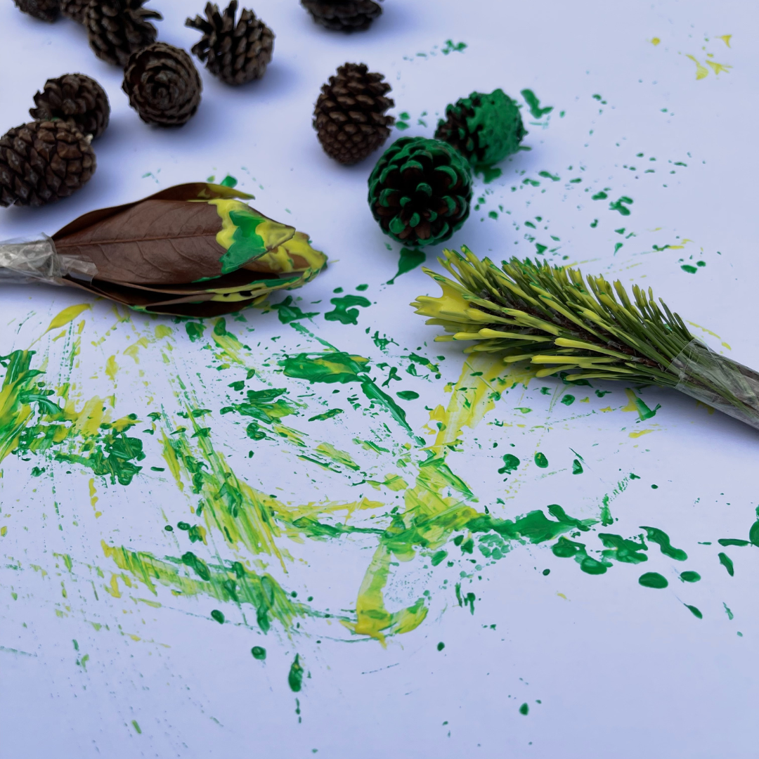 mark making with natural resources and green and yellow paint