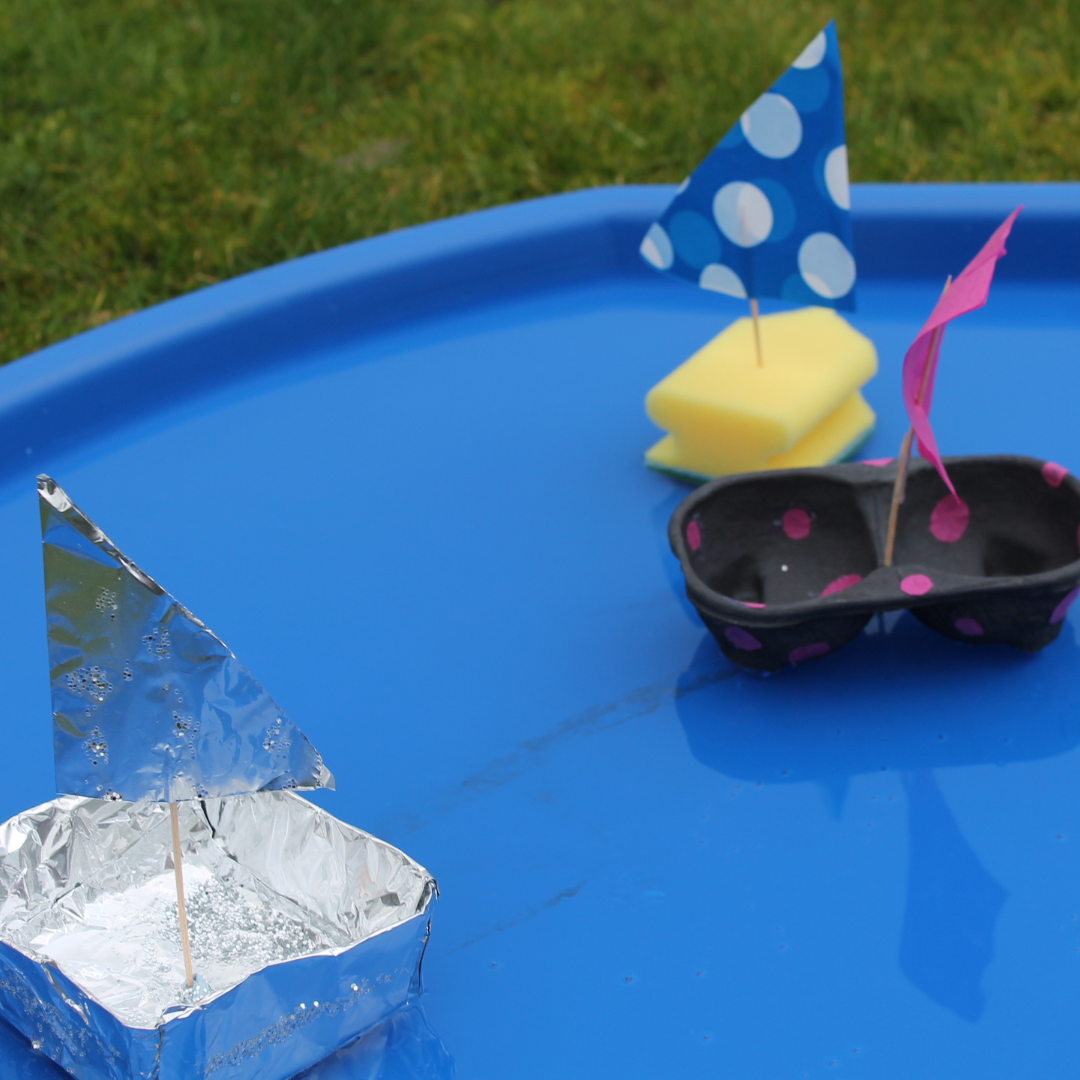 homemade boats floating in a tuff tray