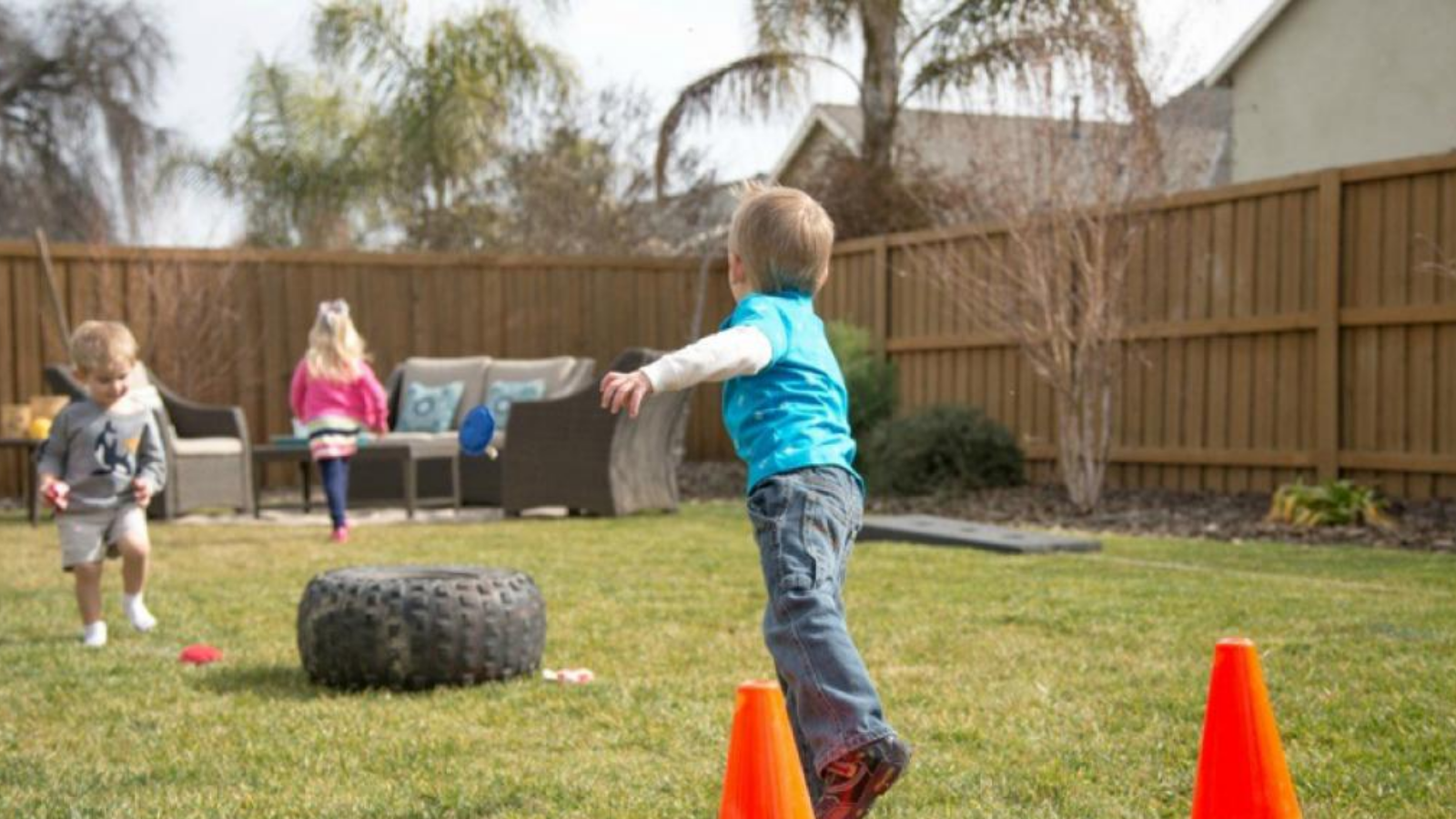 child throwing a beanbag into a tyre from a distance